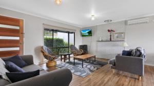 a living room with a couch and a table at 100 on Myer in Lakes Entrance