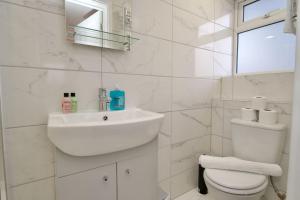 a white bathroom with a sink and a toilet at Dane Apartment 11 – Coventry in Coventry