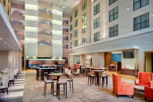 a lobby with tables and chairs in a building at Courtyard Atlanta Decatur Downtown/Emory in Decatur