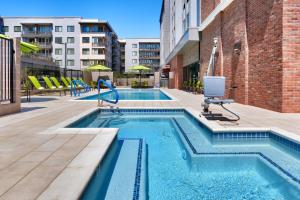 a swimming pool with a chair in a building at SpringHill Suites by Marriott Phoenix Scottsdale in Scottsdale