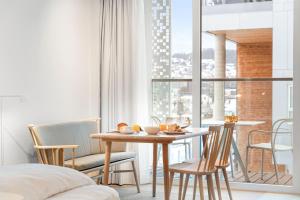 a dining room with a table and chairs and a window at LUX Hotel in Lillestrøm