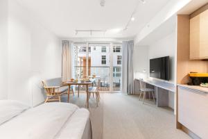 a hotel room with a bed and a table with chairs at LUX Hotel in Lillestrøm