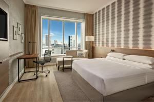 a hotel room with a bed and a desk and a window at Rotterdam Marriott Hotel in Rotterdam