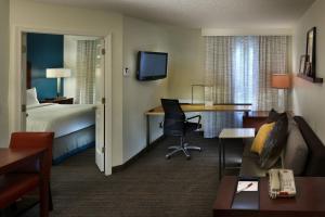 a hotel room with a bed and a desk at Residence Inn Mystic Groton in Mystic +15 photos