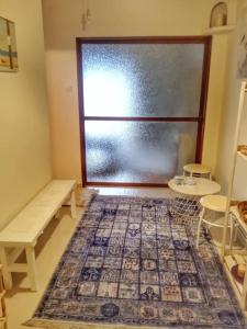 a room with a large glass door with a rug at Skiff_View in Kastoria