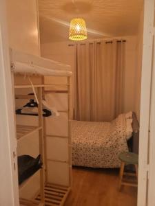 a small bedroom with a bunk bed and a room with a ladder at Charmant appartement près de Montmartre in Paris