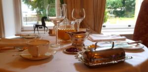曼斯菲爾德的住宿－Ravenscroft B&B，桌子上带眼镜和杯子的桌子