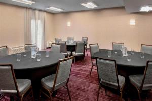 a conference room with tables and chairs with glasses on them at Courtyard Newark Liberty International Airport in Newark