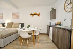 a kitchen and a living room with a table and a bed at Matlock Studio 1 - Coventry in Coventry