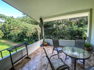 a patio with a table and chairs on a balcony at Lanta Sunshine Residence Apt 4 Two Bed Apartment with AC and Work Space in Ko Lanta