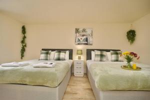two beds sitting next to each other in a bedroom at Matlock Studio 3 – Coventry in Coventry