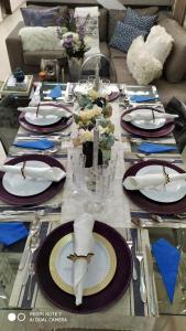 a table with plates and napkins on top at Hotel Boutique Doña Maria in Ocaña