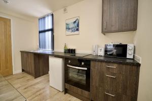 a kitchen with a counter top and a microwave at Matlock Studio 4 - Coventry in Coventry