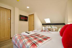 a hotel room with two beds with red pillows at Matlock Studio 5 - Coventry in Coventry