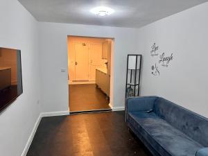 a living room with a couch and a hallway at Dunedin Heights in London