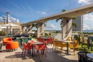 a patio with tables and chairs on a roof at AC Hotel Miami Wynwood in Miami