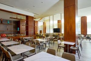 un restaurante con mesas y sillas y TV en Residence Inn Arlington Capital View en Arlington