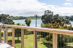 a view of the water from the deck of a house at Studio Puriri, Vibrant, Artistic Studio in Raglan
