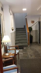 een kamer met een trap met stoelen en een tafel bij Isabel in Cudillero