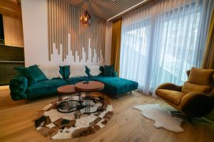 een woonkamer met een groene bank en een tafel bij Luxury Apartment 1984 in Bjelašnica +37 foto's
