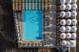 an overhead view of a swimming pool next to a building at Sheraton Grand Tel Aviv in Tel Aviv