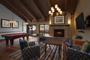 a living room with a pool table and a fireplace at Marriott's StreamSide Douglas at Vail in Vail