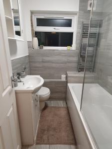 a bathroom with a sink and a toilet and a shower at Serviced Accommodation near London and Stansted - 2 bedrooms  in Harlow