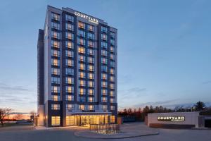 a building with a sign on the front of it at Courtyard by Marriott Kitchener in Kitchener