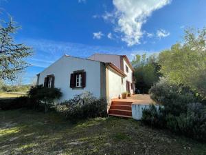 ein kleines weißes Haus mit einer Veranda und einer Treppe in der Unterkunft Casa do Reguengo (New!) in Castelo de Vide