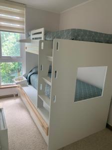 a white bunk bed in a room with a window at Hermoso Entorno y Vista Espectacular en Pucon in Pucón +20 photos