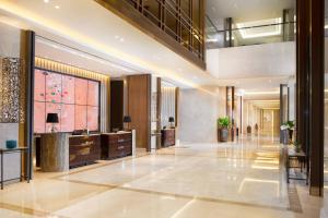 a lobby of a hotel with a reception desk at Sheraton Grand Jakarta Gandaria City Hotel in Jakarta