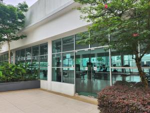 an office building with glass windows and a courtyard at Meridin Bayvue in Masai