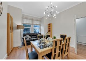 a dining room and living room with a table and chairs at Relaxing 1BR Flat - Cozy and comfortable in London