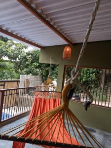 a hammock on the porch of a house at Sierra Kay Hostel in Guachaca