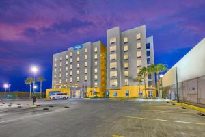 a parking lot in front of a large building at City Express by Marriott Mexicali in Mexicali