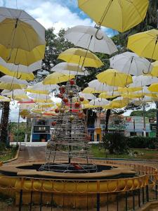 a fountain with yellow and white umbrellas at Araçariguama in Araçariguama