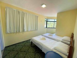 a bedroom with two beds and a window at Apartamento na praia da tabuba com vista mar in Caucaia +32 photos