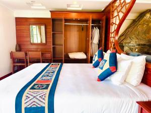 薩帕的住宿－Green Villa Sapa，一间卧室配有一张带蓝白色枕头的大床
