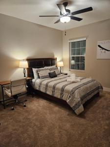 a bedroom with a bed and a ceiling fan at Endearing Private Bedroom in Shared House in Reunion Resort in Kissimmee