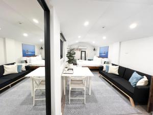 a living room with couches and a table at Dalziel Lodge in Sydney