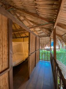 a room with a bed and a wooden floor at Casa Zinpar in Palomino