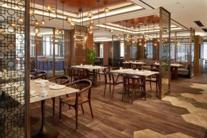 a restaurant with tables and chairs in a room at Daegu Marriott Hotel in Daegu