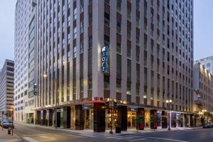 a large building on a city street with a street at Aloft New Orleans Downtown in New Orleans