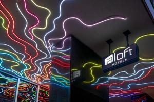 a building with a lit up wall with a neon sign at Aloft by Marriott New Orleans Downtown in New Orleans