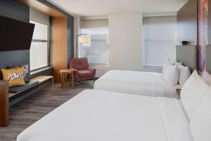 a hotel room with two beds and a tv at Aloft by Marriott New Orleans Downtown in New Orleans +47 photos