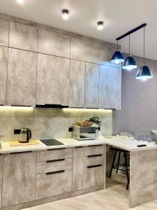a kitchen with stainless steel cabinets and a counter at Landmark Astana 2 комнатные апартаменты in Astana