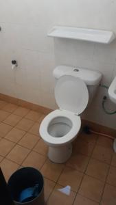 La salle de bains est pourvue de toilettes blanches et d'une poubelle. dans l'établissement Tiara Beach Resort Cozy Studio Apartment, à Port Dickson