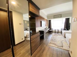 a hotel room with a bedroom and a bathroom at Bertam Resort,Penang in Kepala Batas