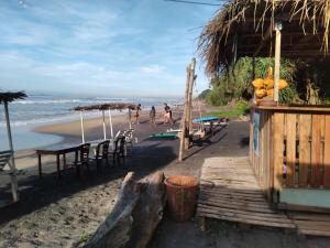 a group of people walking on the beach at Guillet Beach Home in Matara