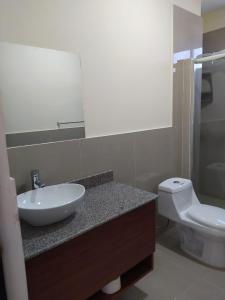 a bathroom with a sink and a toilet at Turqueza Home in Esmeraldas